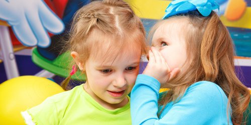 a child telling her friend about the benefit of milk teeth