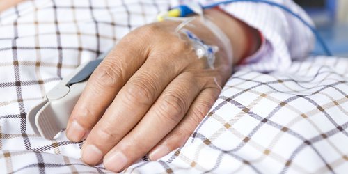 someone's hand being infused because of an illness