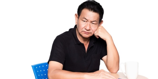 man sitting on the chair thinking about his mouth problem