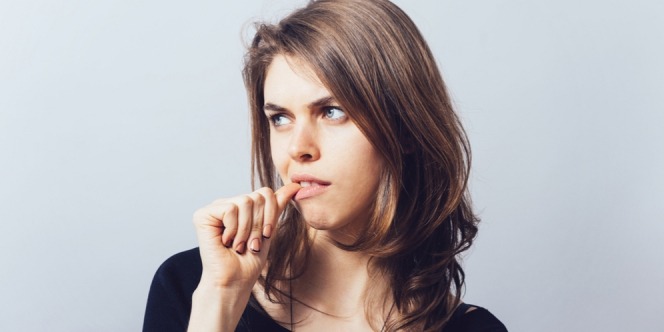 Woman whose bad habits are nails biting