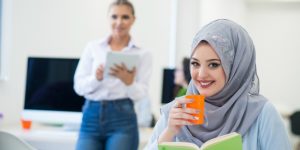 veiled women are reading and drinking